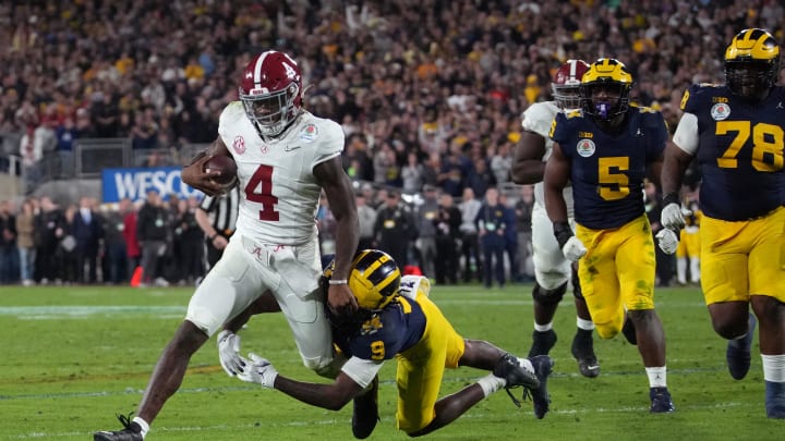 Jan 1, 2024; Pasadena, CA, USA; Alabama Crimson Tide quarterback Jalen Milroe (4) is tackled by Michigan Wolverines defensive back Rod Moore (9) during overtime in the 2024 Rose Bowl college football playoff semifinal game at Rose Bowl. Mandatory Credit: Kirby Lee-USA TODAY Sports