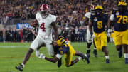 Jan 1, 2024; Pasadena, CA, USA; Alabama Crimson Tide quarterback Jalen Milroe (4) is tackled by Michigan Wolverines defensive back Rod Moore (9) during overtime in the 2024 Rose Bowl college football playoff semifinal game at Rose Bowl.