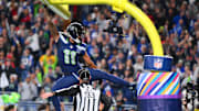 Oct 20, 2025; Seattle, Washington, USA; Seattle Seahawks wide receiver Jaxon Smith-Njigba (11) celebrates on the goal post after a touchdown during the first quarter against the Houston Texans at Lumen Field. Mandatory Credit: Steven Bisig-Imagn Images