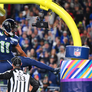 Oct 20, 2025; Seattle, Washington, USA; Seattle Seahawks wide receiver Jaxon Smith-Njigba (11) celebrates on the goal post after a touchdown during the first quarter against the Houston Texans at Lumen Field. Mandatory Credit: Steven Bisig-Imagn Images