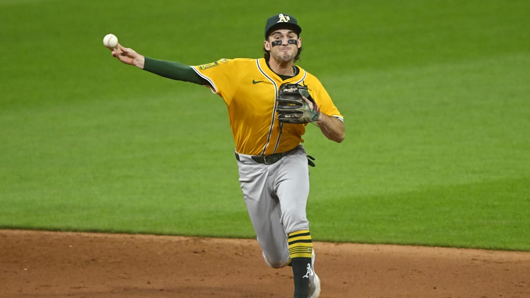 Jul 19, 2025; Cleveland, Ohio, USA; Athletics shortstop Jacob Wilson (5) throws to first base in the sixth inning against the Cleveland Guardians at Progressive Field. Mandatory Credit: David Richard-Imagn Images