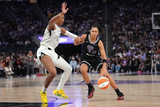 Golden State Valkyries forward Janelle Salaun dribbles the ball next to Las Vegas Aces center A'ja Wilson. 
