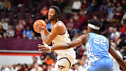 Mar 4, 2025; Blacksburg, Virginia, USA; Virginia Tech Hokies forward Mylyjael Poteat (34) looks to pass the ball asNorth Carolina Tar Heels forward Ven-Allen Lubin (22) defends during the first half at Cassell Coliseum. Mandatory Credit: Brian Bishop-Imagn Images