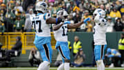 Nov 2, 2025; Green Bay, Wisconsin, USA; Carolina Panthers running back Rico Dowdle (5) celebrates with offensive tackle Yosh Nijman (77) and wide receiver Xavier Legette (17) after a touchdown during the second half against the Green Bay Packers at Lambeau Field. Mandatory Credit: Jeff Hanisch-Imagn Images