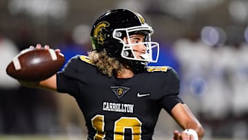 Oct 20, 2023; Carrollton, GA, USA; Carrollton Trojans quarterback Julian Lewis (10) drops back to pass against the Westlake Lions during the first half at Grisham Stadium. The 15-year-old Carrollton High student has already committed to playing for the University of Southern California Trojans and has been considered one of the top high school quarterback prospects. Mandatory Credit: John David Mercer-Imagn Images