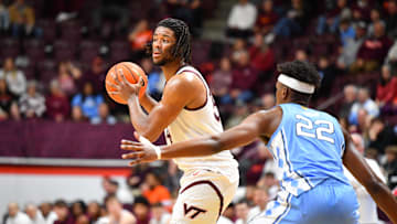 Mar 4, 2025; Blacksburg, Virginia, USA; Virginia Tech Hokies forward Mylyjael Poteat (34) looks to pass the ball asNorth Carolina Tar Heels forward Ven-Allen Lubin (22) defends during the first half at Cassell Coliseum. Mandatory Credit: Brian Bishop-Imagn Images
