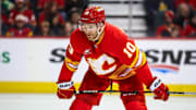 Feb 23, 2025; Calgary, Alberta, CAN; Calgary Flames left wing Jonathan Huberdeau (10) during the face off against the San Jose Sharks during the second period at Scotiabank Saddledome. Mandatory Credit: Sergei Belski-Imagn Images