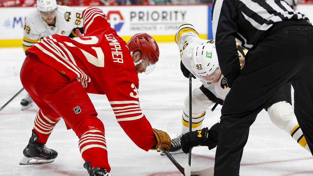 Mar 21, 2026; Detroit, Michigan, USA; Detroit Red Wings left wing J.T. Compher (37) faces off against Boston Bruins center Fraser Minten (93) during the third period at Little Caesars Arena. Mandatory Credit: Brian Bradshaw Sevald-Imagn Images