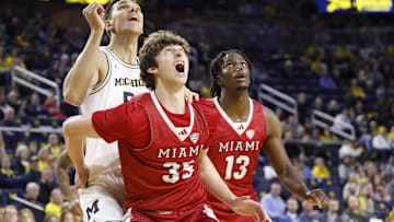 Nov 18, 2024; Ann Arbor, Michigan, USA;  Michigan Wolverines center Vladislav Goldin (50) Miami (Oh) Redhawks center Reece Potter (35) and forward Antwone Woolfolk (13) look for a rebound in the first half at Crisler Center. Mandatory Credit: Rick Osentoski-Imagn Images