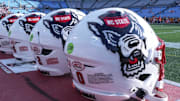 Sep 7, 2024; Charlotte, North Carolina, USA; North Carolina State Wolfpack helmets during pregame activity for the Dukes Mayo Classic against the Tennessee Volunteers at Bank of America Stadium. Mandatory Credit: Jim Dedmon-Imagn Images