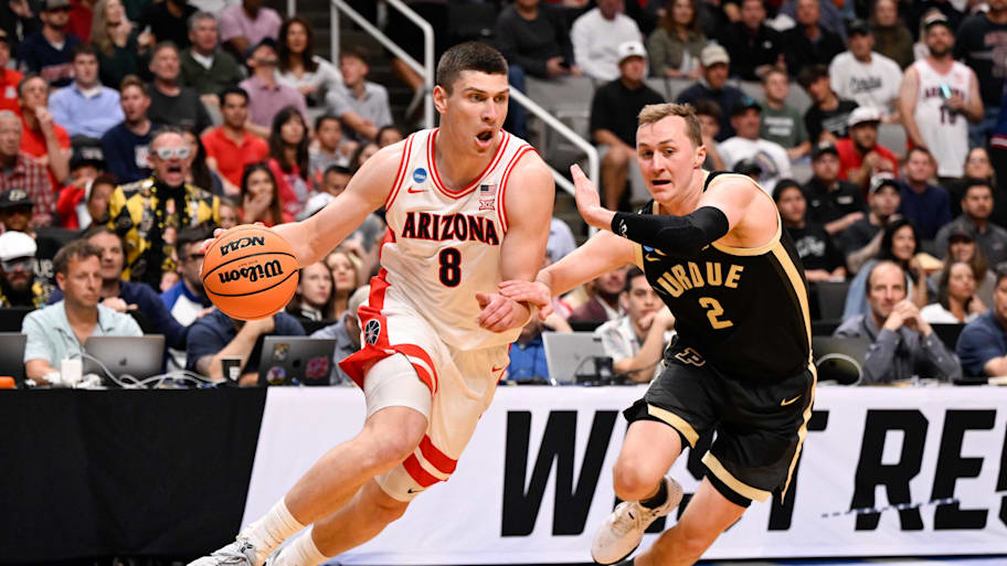 Arizona forward Ivan Kharchenkov drives against Purdue guard Fletcher Loyer during the West Regional final.