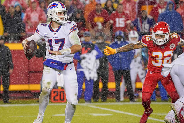 Buffalo Bills quarterback Josh Allen looks to pass as Kansas City Chiefs free safety Tyrann Mathieu defends.