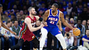 Apr 17, 2024; Philadelphia, Pennsylvania, USA; Philadelphia 76ers center Joel Embiid (21) controls the ball against Miami Heat forward Kevin Love (42) during the first quarter of a play-in game of the 2024 NBA playoffs at Wells Fargo Center. Mandatory Credit: Bill Streicher-Imagn Images