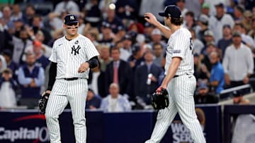 Oct 30, 2024; New York, New York, USA; New York Yankees first baseman Anthony Rizzo (48) talks with pitcher Gerrit Cole (45) after Cole didn’t cover first base allowing a base hit during the fifth inning against the Los Angeles Dodgers in game four of the 2024 MLB World Series at Yankee Stadium. Mandatory Credit: Brad Penner-Imagn Images