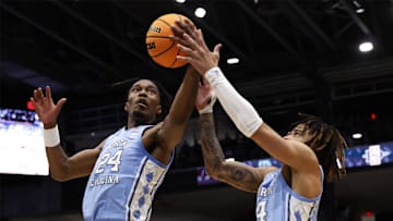 Mar 18, 2025; Dayton, OH, USA; North Carolina Tar Heels forward Jae'Lyn Withers (24) and guard RJ Davis (4) control the ball in the first half against the San Diego State Aztecs  at UD Arena. Mandatory Credit: Rick Osentoski-Imagn Images