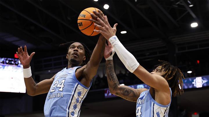 Mar 18, 2025; Dayton, OH, USA; North Carolina Tar Heels forward Jae'Lyn Withers (24) and guard RJ Davis (4) control the ball in the first half against the San Diego State Aztecs  at UD Arena. Mandatory Credit: Rick Osentoski-Imagn Images