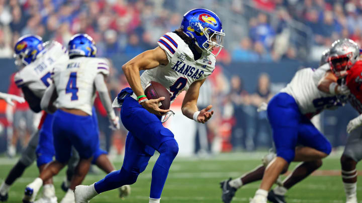 Dec 26, 2023; Phoenix, AZ, USA; Kansas Jayhawks quarterback Jason Bean (9) runs with the ball during the second half against the UNLV Rebels in the Guaranteed Rate Bowl at Chase Field. Mandatory Credit: Mark J. Rebilas-USA TODAY Sports