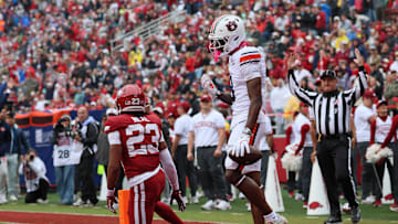 Oct 25, 2025; Fayetteville, Arkansas, USA; Auburn Tigers wide receiver Cam Coleman (8) celebrates after scoring a touchdown defended by Arkansas Razorbacks defensive back Julian Neal (23) during the first quarter at Donald W. Reynolds Razorback Stadium. Mandatory Credit: Nelson Chenault-Imagn Images