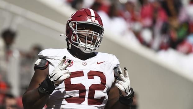 Alabama offensive lineman Tyler Booker celebrates after the offense scored a touchdown during the A-Day scrimmage. 