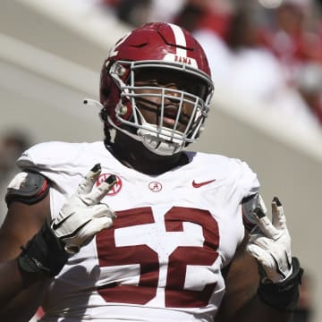 Apr 13, 2024; Tuscaloosa, AL, USA;  Alabama offensive lineman Tyler Booker (52) celebrates after the offense scored a touchdown during the A-Day scrimmage at Bryant-Denny Stadium. Mandatory Credit: Gary Cosby Jr.-USA TODAY Sports