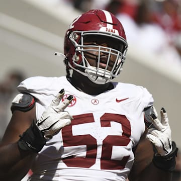 Apr 13, 2024; Tuscaloosa, AL, USA;  Alabama offensive lineman Tyler Booker (52) celebrates after the offense scored a touchdown during the A-Day scrimmage at Bryant-Denny Stadium. Mandatory Credit: Gary Cosby Jr.-Imagn Images