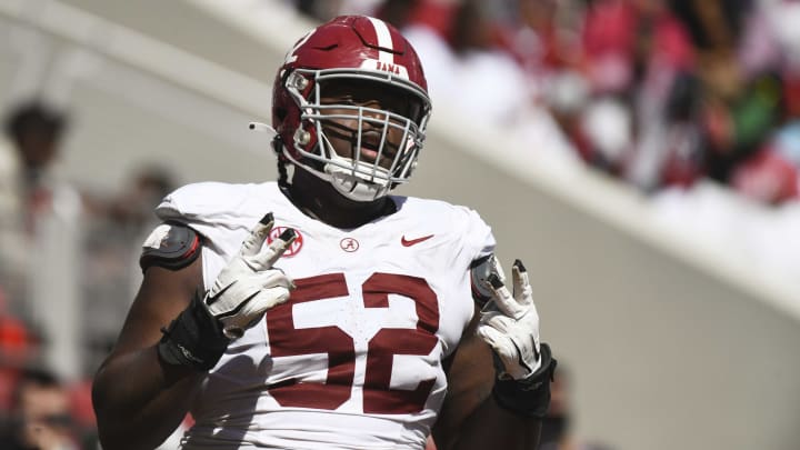 Alabama offensive lineman Tyler Booker (52) celebrates after the offense scored a touchdown during the A-Day scrimmage at Bryant-Denny Stadium.  He is one of nine former Florida high school football players, and one of four from IMG Academy, to be named 2024 Preseason All-SEC.