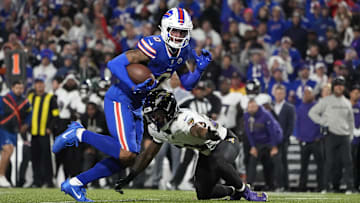 Sep 7, 2025; Orchard Park, New York, USA;  Buffalo Bills wide receiver Keon Coleman (0) runs the ball against Baltimore Ravens cornerback Jaire Alexander (23) during the fourth quarter at Highmark Stadium. Mandatory Credit: Gregory Fisher-Imagn Images