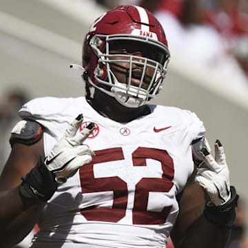 Apr 13, 2024; Tuscaloosa, AL, USA;  Alabama offensive lineman Tyler Booker (52) celebrates after the offense scored a touchdown during the A-Day scrimmage at Bryant-Denny Stadium. Mandatory Credit: Gary Cosby Jr.-Imagn Images