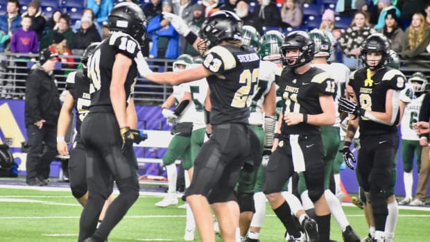 Shea Stevenson and Benson Jenks celebrate a tackle in Royal's WIAA Class 1A championship game win over Lakeside of Nine Mile 