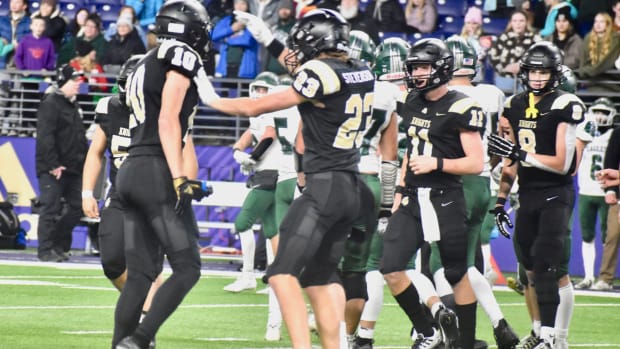 Shea Stevenson and Benson Jenks celebrate a tackle in Royal's WIAA Class 1A championship game win over Lakeside of Nine Mile 