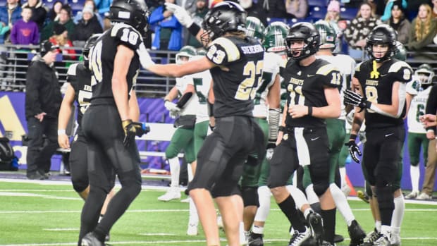 Shea Stevenson and Benson Jenks celebrate a tackle in Royal's WIAA Class 1A championship game win over Lakeside of Nine Mile 