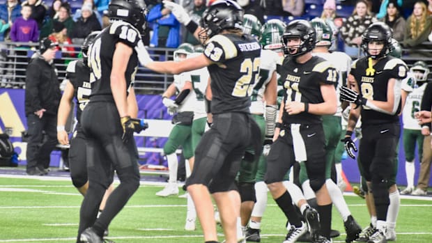 Shea Stevenson and Benson Jenks celebrate a tackle in Royal's WIAA Class 1A championship game win over Lakeside of Nine Mile 
