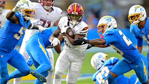 Washington Commanders running back Jacory Croskey-Merritt (22) runs past Los Angeles Chargers defense