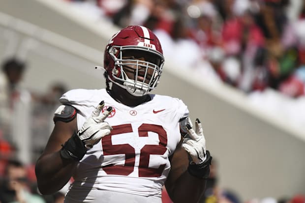 Alabama OG Tyler Booker celebrates after the offense scored a touchdown during the A-Day scrimmage.