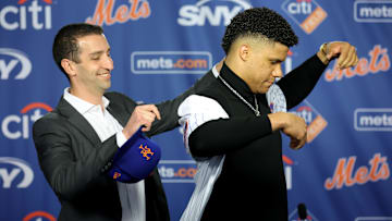 Dec 12, 2024; Flushing, NY, USA; New York Mets general manager David Stearns puts a jersey on new right fielder Juan Soto during Soto's introductory press conference at Citi Field. Mandatory Credit: Brad Penner-Imagn Images