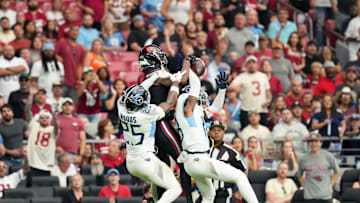 Arizona Cardinals receiver Marvin Harrison Jr. (18) makes a first-down catch over Tennessee Titans defenders Jalyn Armour-Davis (18) and Xavier Woods (25) at State Farm Stadium in Glendale on Oct. 5, 2025.