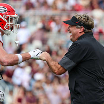Starkville, Mississippi, USA; Georgia Bulldogs head coach Kirby Smart and tight end Oscar Delp (4) react after a touchdown against the Mississippi State Bulldogs during the first half at Davis Wade Stadium at Scott Field.