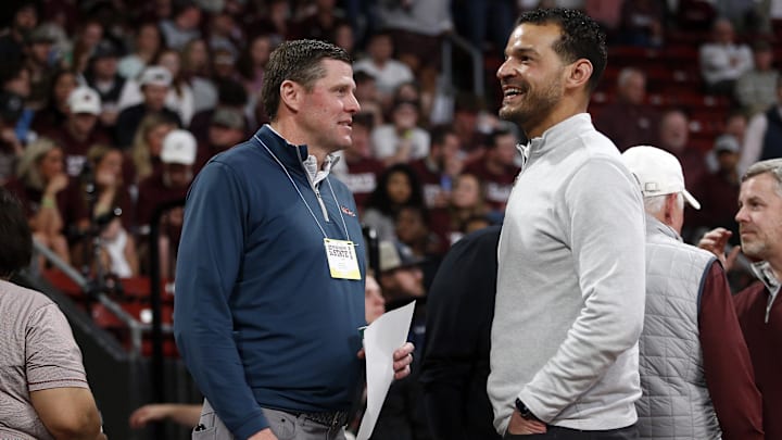 Feb 21, 2024; Starkville, Mississippi, USA; Mississippi Rebels athletic director Keith Carter (left) and Mississippi State Bulldogs athletic director Zac Selmon (right) talk during halftime at Humphrey Coliseum. Mandatory Credit: Petre Thomas-Imagn Images