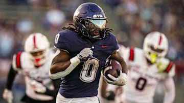 Sep 20, 2025; East Hartford, Connecticut, USA; Connecticut Huskies running back Cam Edwards (0) runs the ball for a touchdown against et Ball State Cardinals in the second half at Pratt & Whitney Stadium at Rentschler Field. Mandatory Credit: David Butler II-Imagn Images