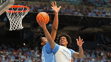 Oct 4, 2025; Charlotte, NC, USA; North Carolina Tar Heels guard Jonathan Powell (11) shoots as forward Jarin Stevenson (15) defends in the first half at Dean E. Smith Center. Mandatory Credit: Bob Donnan-Imagn Images