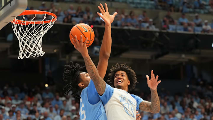 Oct 4, 2025; Charlotte, NC, USA; North Carolina Tar Heels guard Jonathan Powell (11) shoots as forward Jarin Stevenson (15) defends in the first half at Dean E. Smith Center. Mandatory Credit: Bob Donnan-Imagn Images