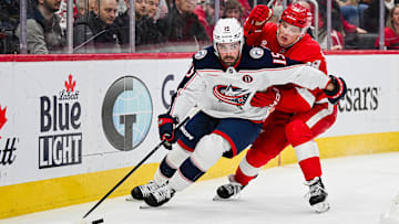 Feb 27, 2025; Detroit, Michigan, USA; Columbus Blue Jackets defenseman Dante Fabbro (15) controls the puck defended by Detroit Red Wings right wing Jonatan Berggren (48) during the second period at Little Caesars Arena. Mandatory Credit: Tim Fuller-Imagn Images