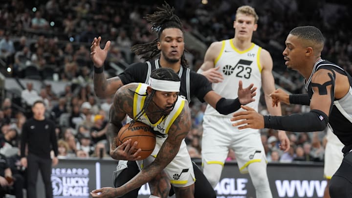 Nov 9, 2024; San Antonio, Texas, USA;  Utah Jazz guard Jordan Clarkson (00) grabs a loose ball between San Antonio Spurs guard Stephon Castle (5) and San Antonio Spurs forward Keldon Johnson (0) in the second half at Frost Bank Center. Mandatory Credit: Daniel Dunn-Imagn Images