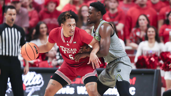 Feb 4, 2025; Lubbock, Texas, USA; Texas Tech Red Raiders forward Darrion Williams (5) dribbles the ball against  Baylor Bears guard Jalen Celestine (32) in the first half at United Supermarkets Arena. Mandatory Credit: Michael C. Johnson-Imagn Images