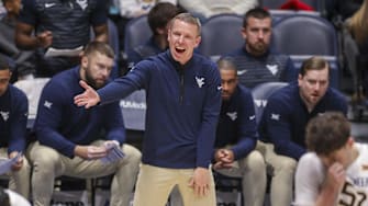 Dec 3, 2025; Morgantown, West Virginia, USA; West Virginia Mountaineers head coach Ross Hodge talks to his players during the first half against the Coppin State Eagles at Hope Coliseum. Mandatory Credit: 