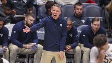 Dec 3, 2025; Morgantown, West Virginia, USA; West Virginia Mountaineers head coach Ross Hodge talks to his players during the first half against the Coppin State Eagles at Hope Coliseum. Mandatory Credit: 