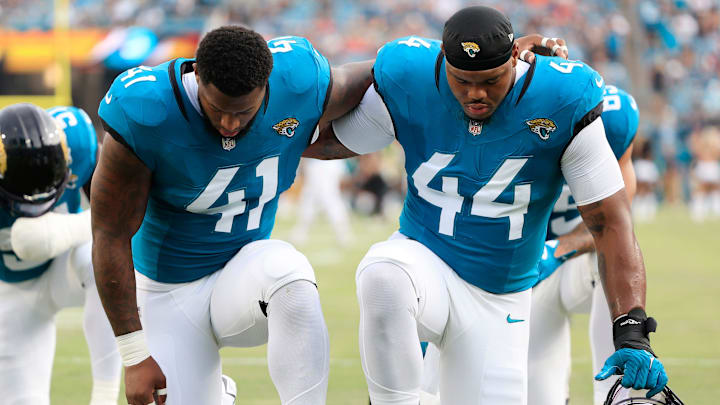 Jacksonville Jaguars defensive end Josh Hines-Allen (41) and defensive end Travon Walker (44) pray before a preseason NFL football game Saturday, Aug. 10, 2024 at EverBank Stadium in Jacksonville, Fla. The Jacksonville Jaguars defeated the Kansas City Chiefs 26-13. [Corey Perrine/Florida Times-Union]