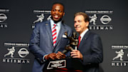 Dec 12, 2015; New York, NY, USA; Alabama running back Derrick Henry (left) and head coach Nick Saban pose with the Heisman Trophy during a press conference at the New York Marriott Marquis after the 81st annual Heisman Trophy presentation. Mandatory Credit: Brad Penner-Imagn Images