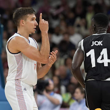 Aug 3, 2024; Villeneuve-d'Ascq, France; Serbia shooting guard Bogdan Bogdanovic (7) reacts after making a shot against South Sudan shooting guard Peter Jok (14) in the fourth quarter during the Paris 2024 Olympic Summer Games at Stade Pierre-Mauroy. Mandatory Credit: John David Mercer-Imagn Images