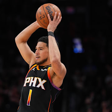 Mar 21, 2025; Phoenix, Arizona, USA; Phoenix Suns guard Devin Booker (1) controls the ball against the Cleveland Cavaliers during the second half at Footprint Center. Mandatory Credit: Joe Camporeale-Imagn Images